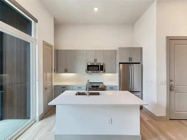 a kitchen with a stove and a refrigerator