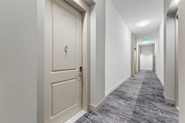 a view of hallway with wooden floor