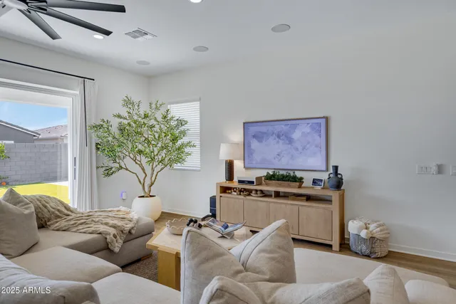 a living room with furniture a potted plant and a fireplace