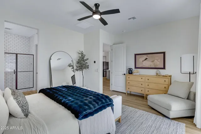 a bedroom with a bed and ceiling fan