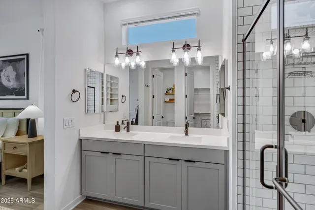 a bathroom with a double vanity sink mirror and shower