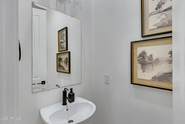 a bathroom with a sink and mirror