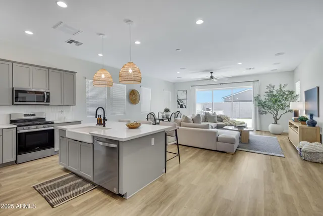 a view of kitchen with sink stove and living room