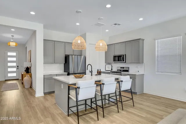 a view of kitchen with cabinets table and chairs