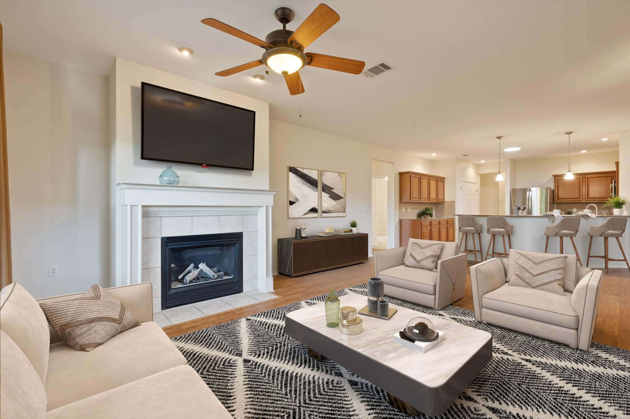 126 Trail Rider Way Georgetown, TX 78633 - Photo 8 of 30 a living room with furniture a flat screen tv and a fireplace