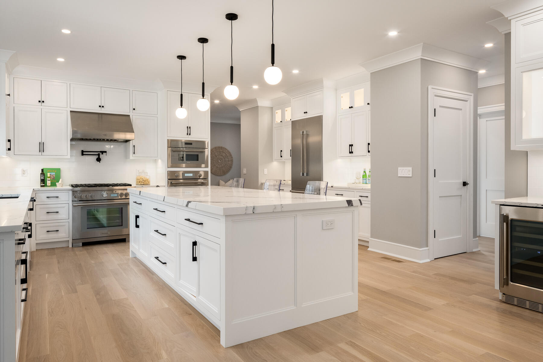 82 Eden Road Stamford, CT 06907 - Photo 13 of 18 a large kitchen with stainless steel appliances kitchen island granite countertop a stove a sink a refrigerator and white cabinets with wooden floor