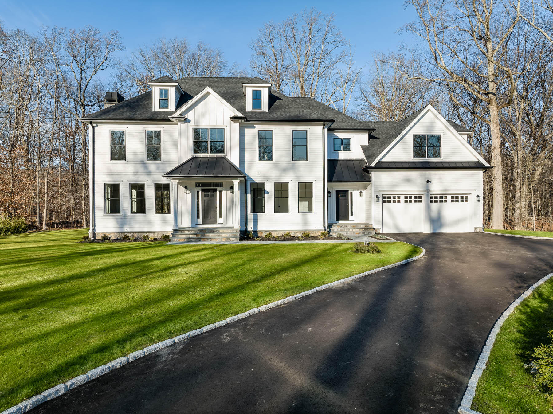 82 Eden Road Stamford, CT 06907 - Photo 3 of 18 a front view of a house with a yard table and chairs
