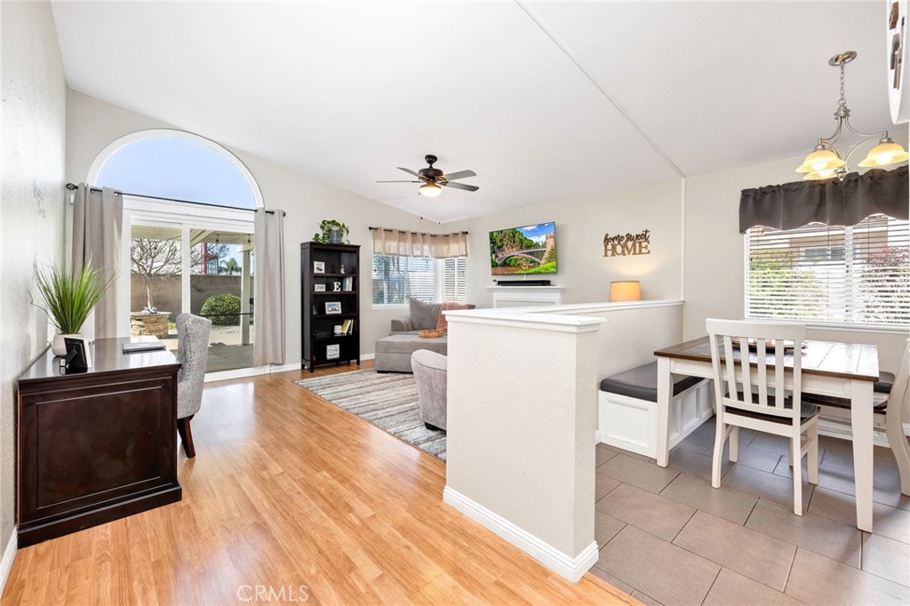 3147 Wimbledon Way Hemet, CA 92545 - Photo 12 of 41 a living room with furniture a dining table and a fireplace