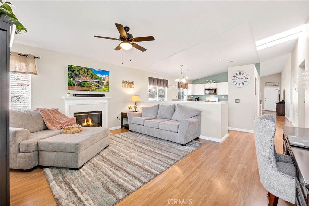 3147 Wimbledon Way Hemet, CA 92545 - Photo 13 of 41 a living room with furniture a fireplace and a flat screen tv