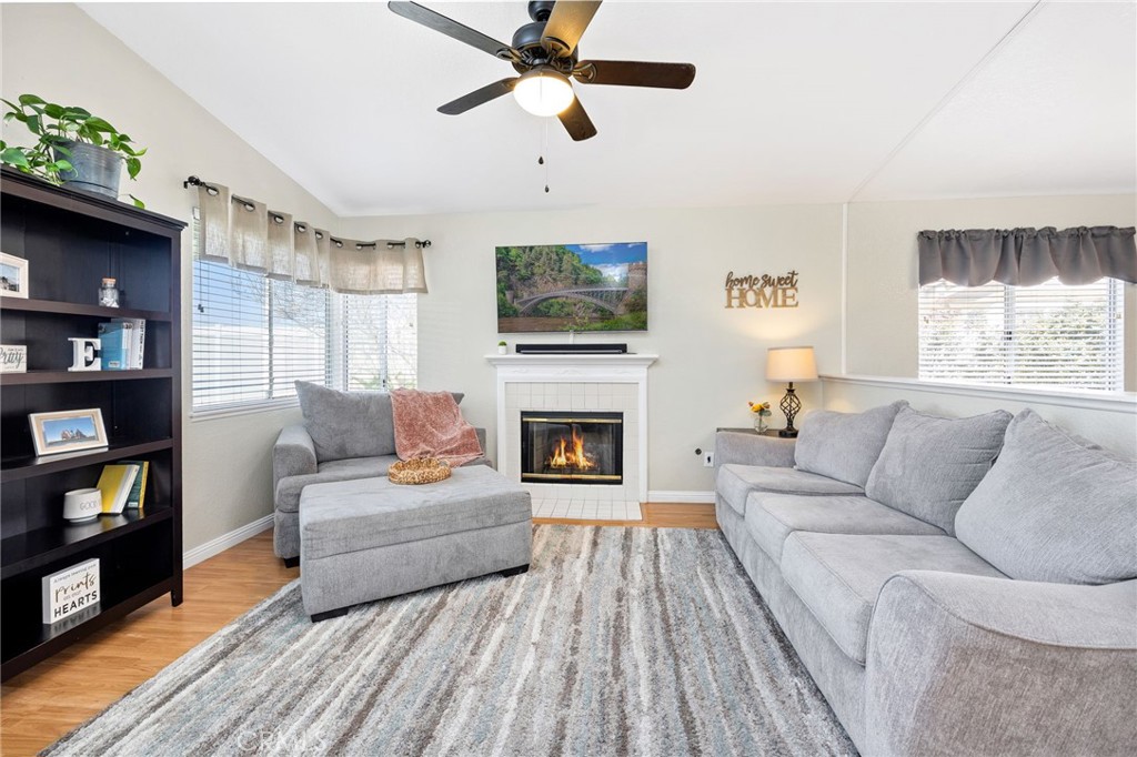 3147 Wimbledon Way Hemet, CA 92545 - Photo 14 of 41 a living room with furniture a fireplace and a flat screen tv