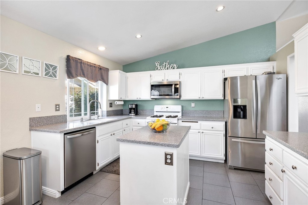 3147 Wimbledon Way Hemet, CA 92545 - Photo 18 of 41 a kitchen with stainless steel appliances a refrigerator sink and microwave