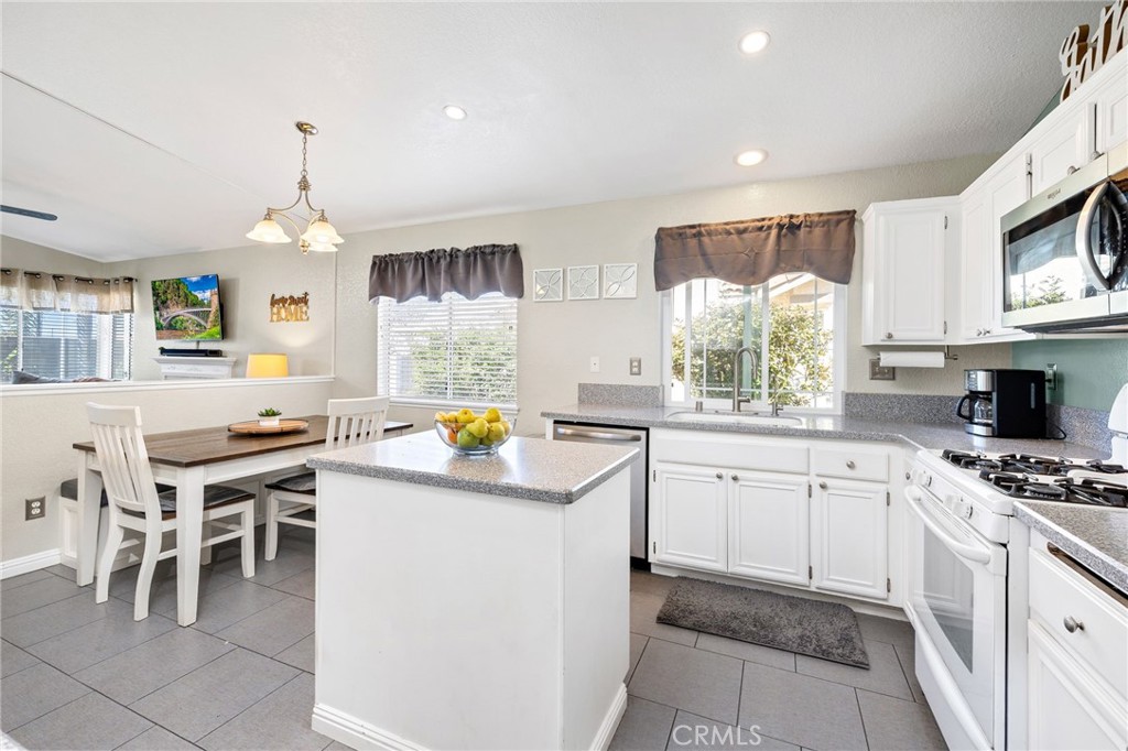3147 Wimbledon Way Hemet, CA 92545 - Photo 23 of 41 a kitchen that has a lot of white cabinets and stainless steel appliances