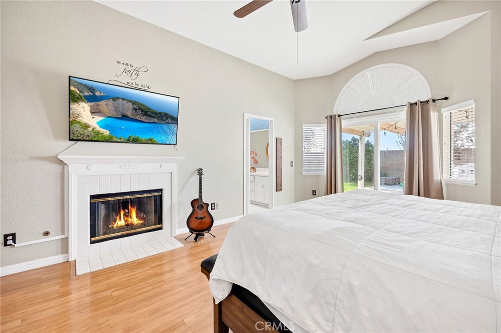 3147 Wimbledon Way Hemet, CA 92545 - Photo 30 of 41 a bedroom with a bed and a fireplace