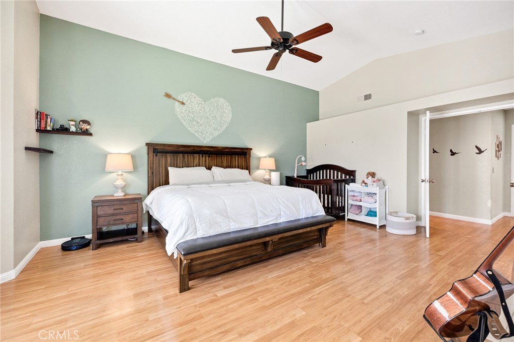 3147 Wimbledon Way Hemet, CA 92545 - Photo 31 of 41 a bedroom with a bed and wooden floor