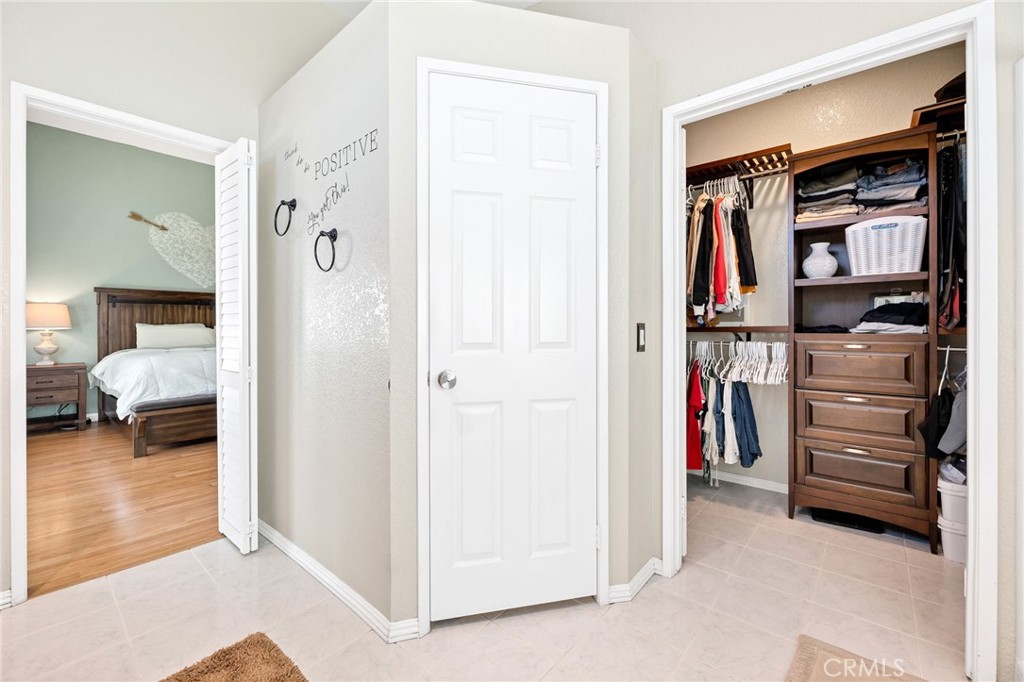 3147 Wimbledon Way Hemet, CA 92545 - Photo 35 of 41 a view of walk in closet with clothes and shoes