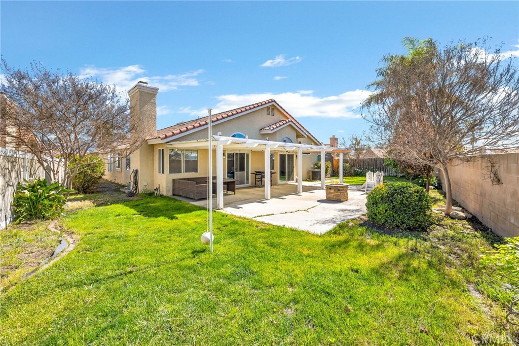 3147 Wimbledon Way Hemet, CA 92545 - Photo 39 of 41 a view of a house with a big yard potted plants and large tree