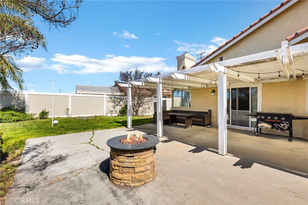 3147 Wimbledon Way Hemet, CA 92545 - Photo 41 of 41 a view of a patio with table and chairs potted plants and a big yard