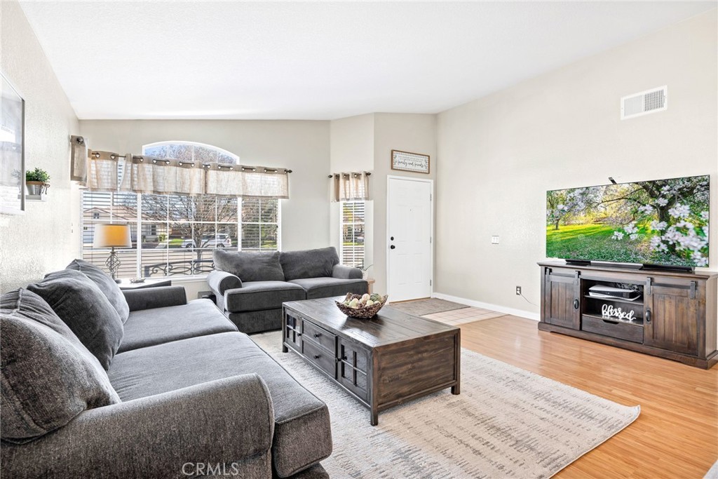 3147 Wimbledon Way Hemet, CA 92545 - Photo 10 of 41 a living room with furniture and a flat screen tv