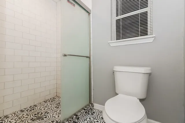 a white toilet sitting next to a bathroom sink