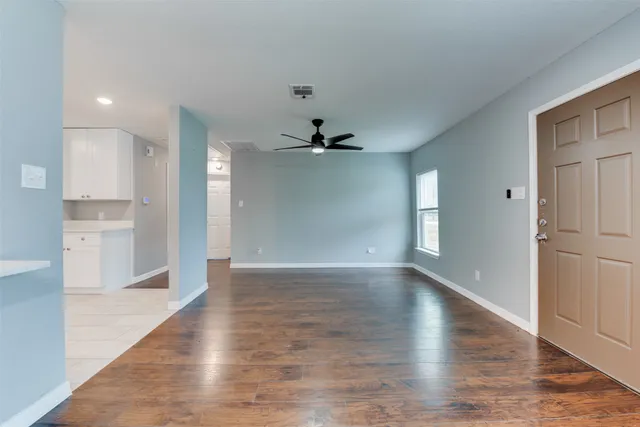 a view of a kitchen with a dishwasher and wooden floor
