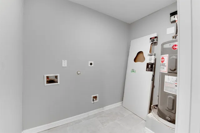 a view of storage and utility room with a refrigerator