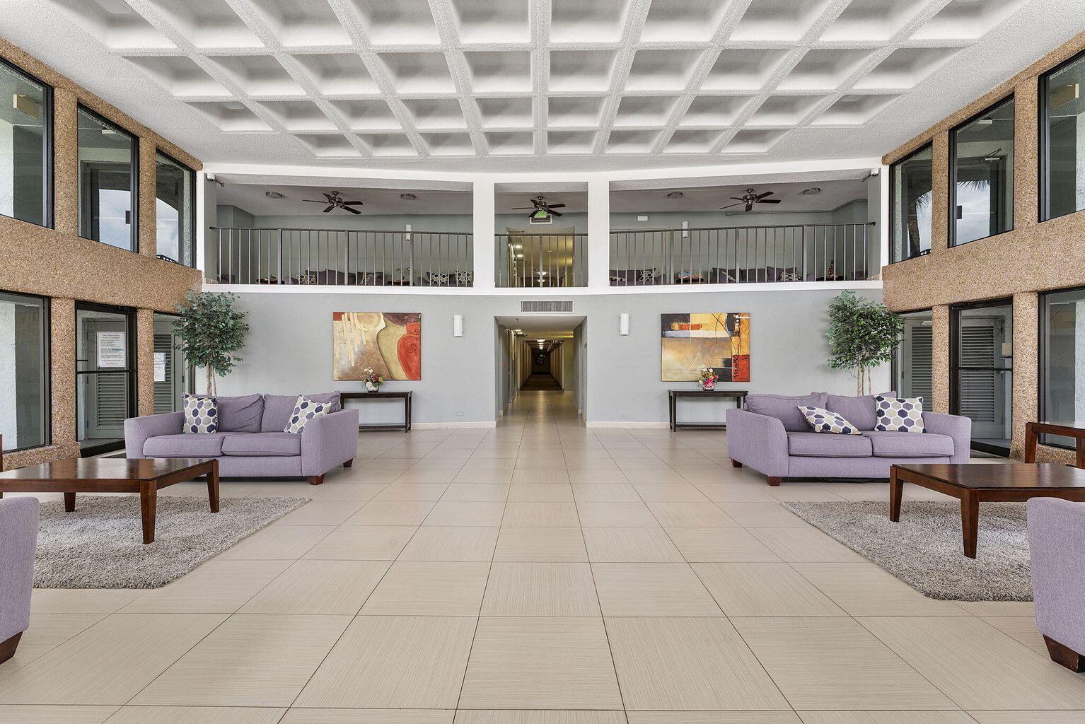 9440 Southwest 8th Street, Unit 318 Boca Raton, FL 33428 - Photo 11 of 11 a living room with furniture and a potted plant