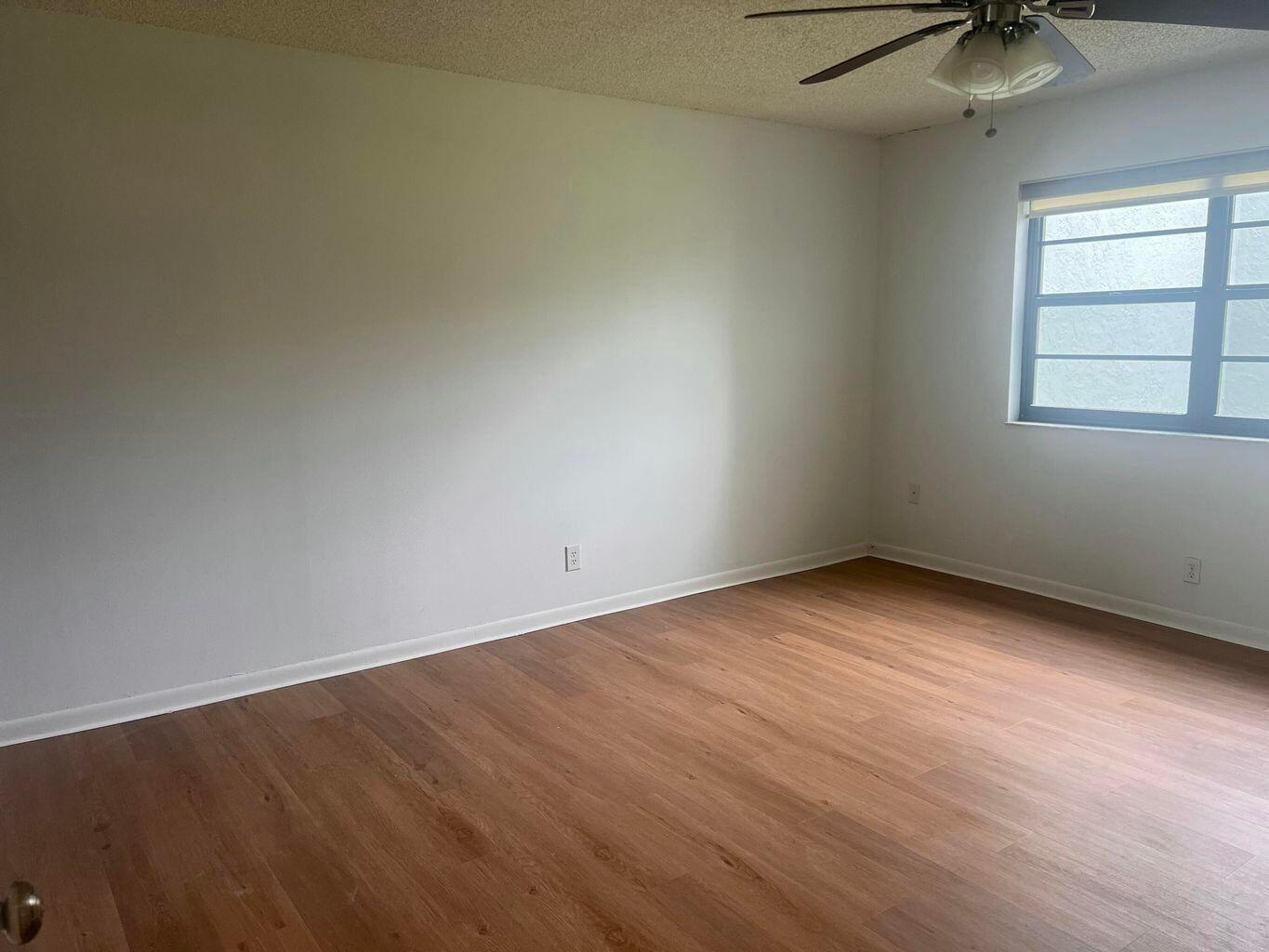 9440 Southwest 8th Street, Unit 318 Boca Raton, FL 33428 - Photo 6 of 11 an empty room with a window