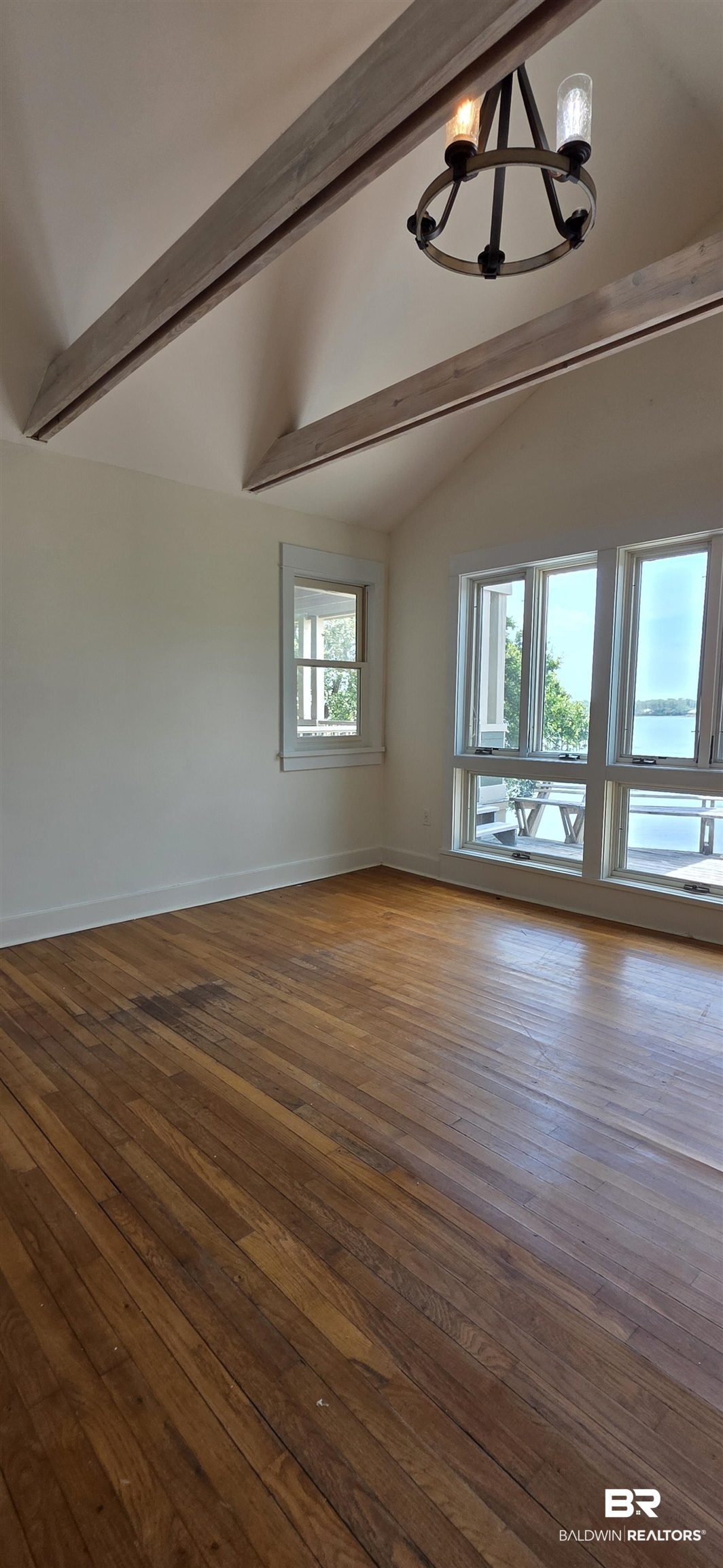 544 Windmill Ridge Road Gulf Shores, AL 36542 - Photo 19 of 50 Spare room featuring a chandelier and dark wood finished floors