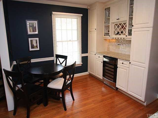 629 Macon Place Raleigh, NC 27609 - Photo 6 of 12 More custom cabinets in the eat in kitchen area, Gleaming hardwoods, This is the perfect space for chilling all sorts of beverages. open to the formal dining room.