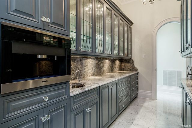 a kitchen with stainless steel appliances granite countertop a stove and a microwave