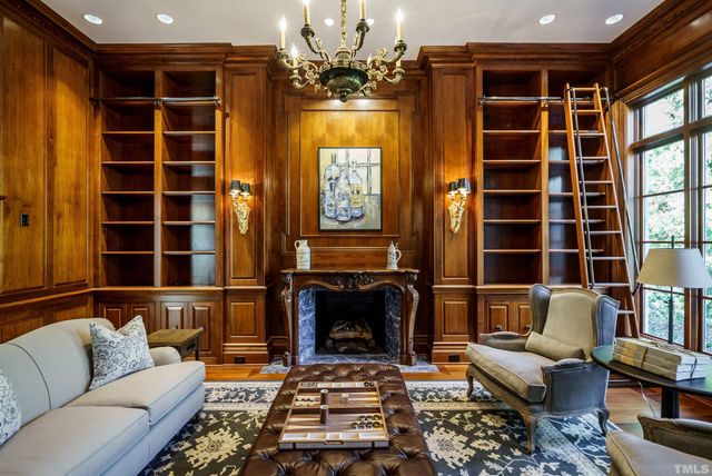 a living room with furniture windows and a fireplace