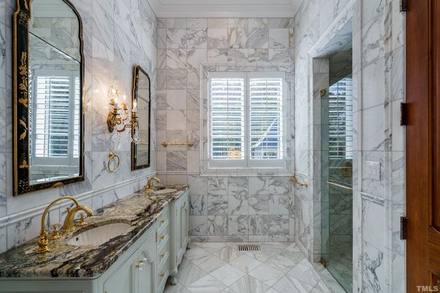 a bathroom with a granite countertop sink a mirror and a shower