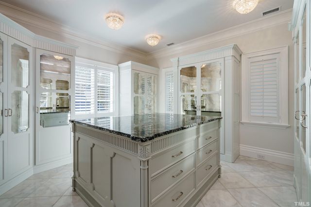 a kitchen with granite countertop a sink and cabinets