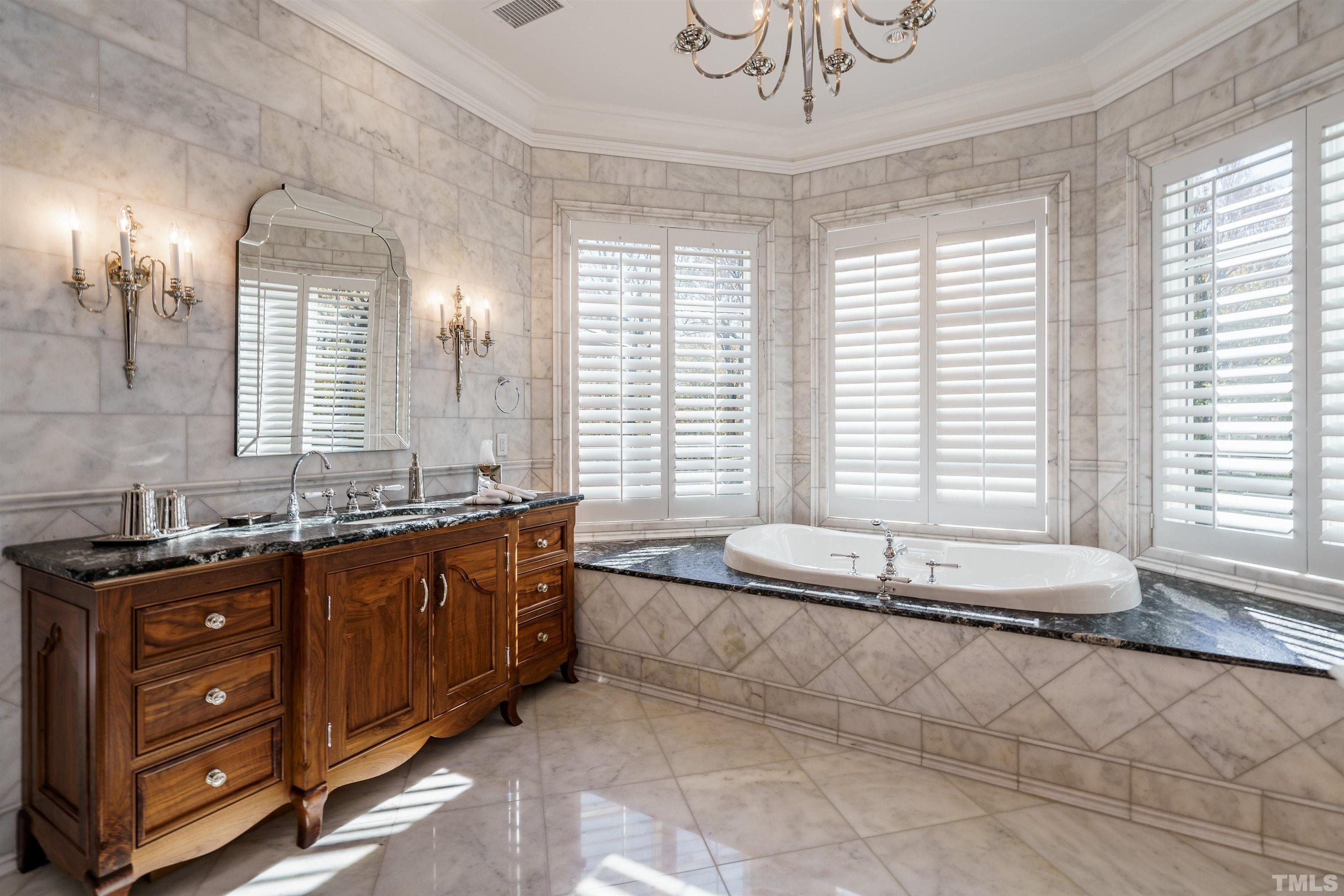 1624 Morning Mountain Road Raleigh, NC 27614 - Photo 22 of 30 a spacious bathroom with a granite countertop tub a double vanity sink a large mirror and a bathtub in shower