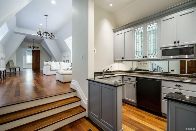a kitchen with sink cabinets and appliances