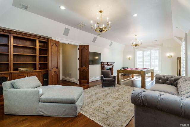 a living room with furniture and a chandelier