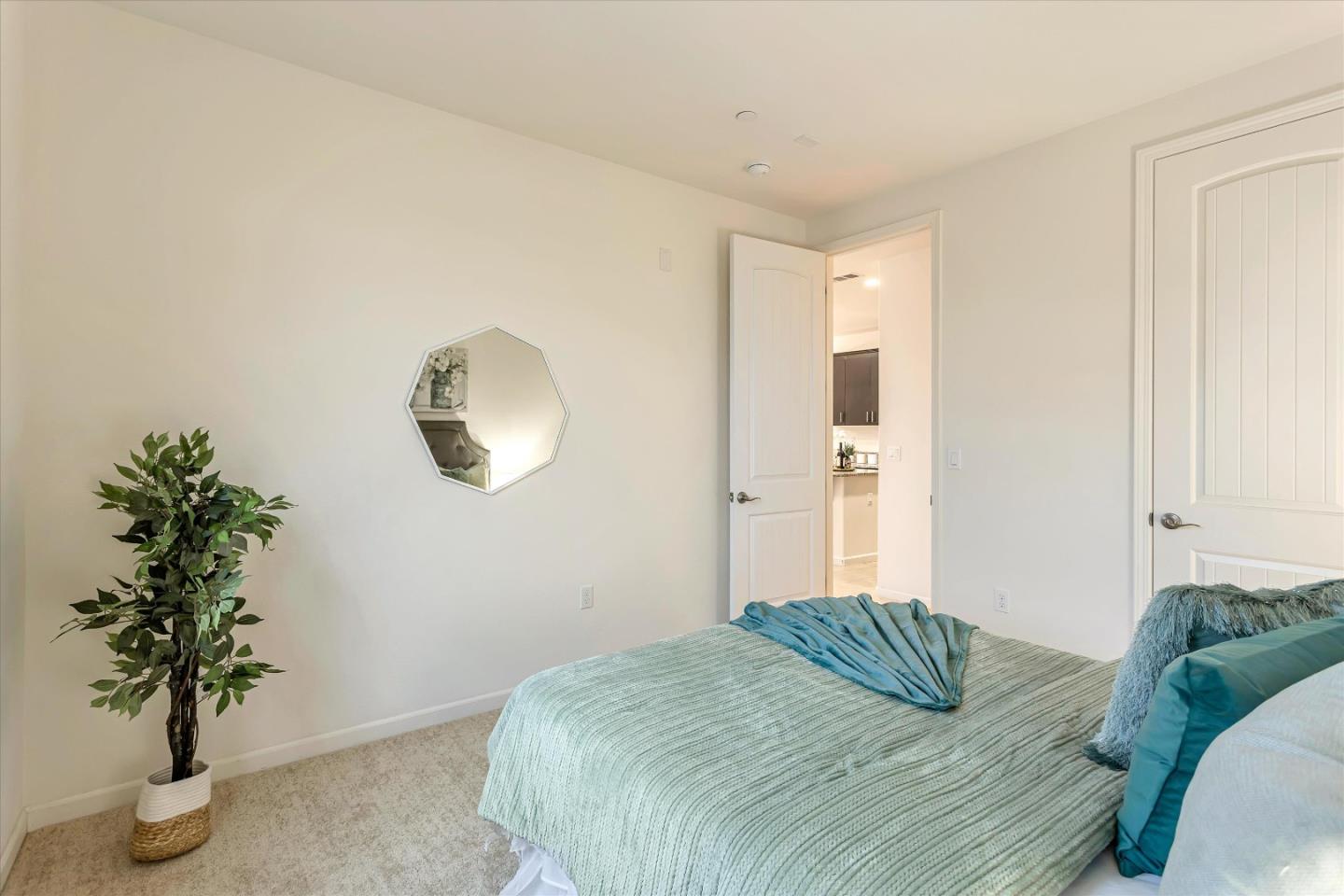 1886 Trento Loop Milpitas, CA 95035 - Photo 14 of 43 a bedroom with a bed and a potted plant