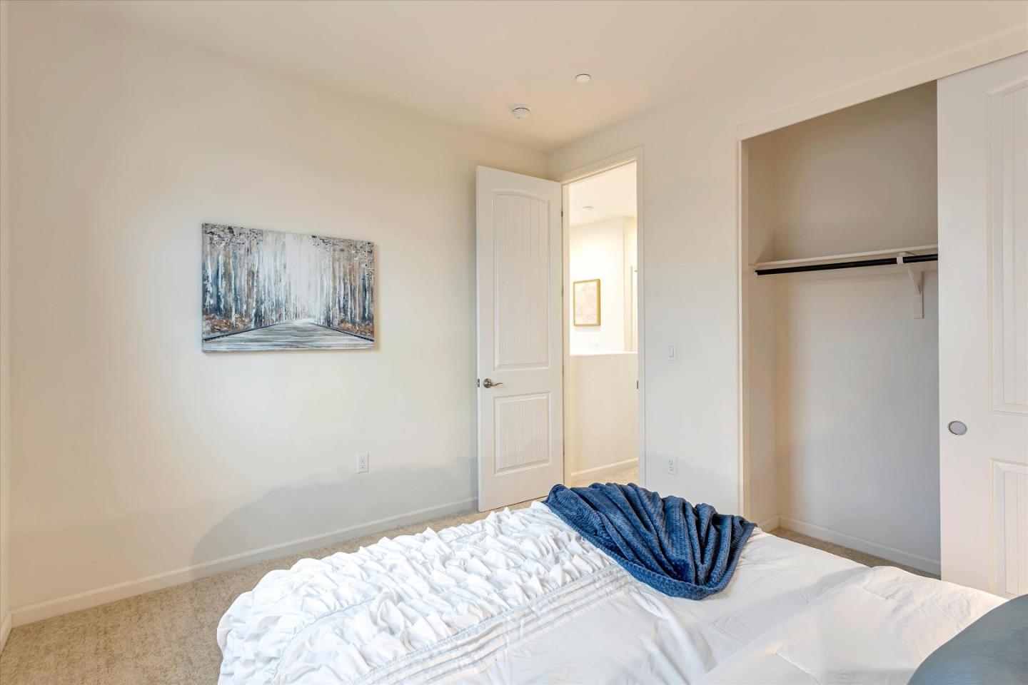 1886 Trento Loop Milpitas, CA 95035 - Photo 17 of 43 a bedroom with a bed and a painting on the wall