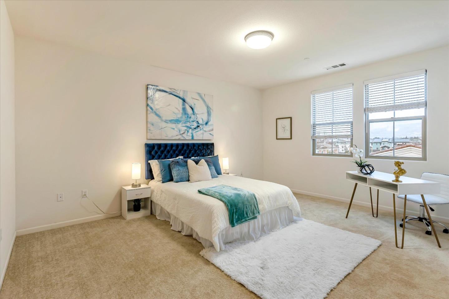 1886 Trento Loop Milpitas, CA 95035 - Photo 19 of 43 a bedroom with a bed a table and windows