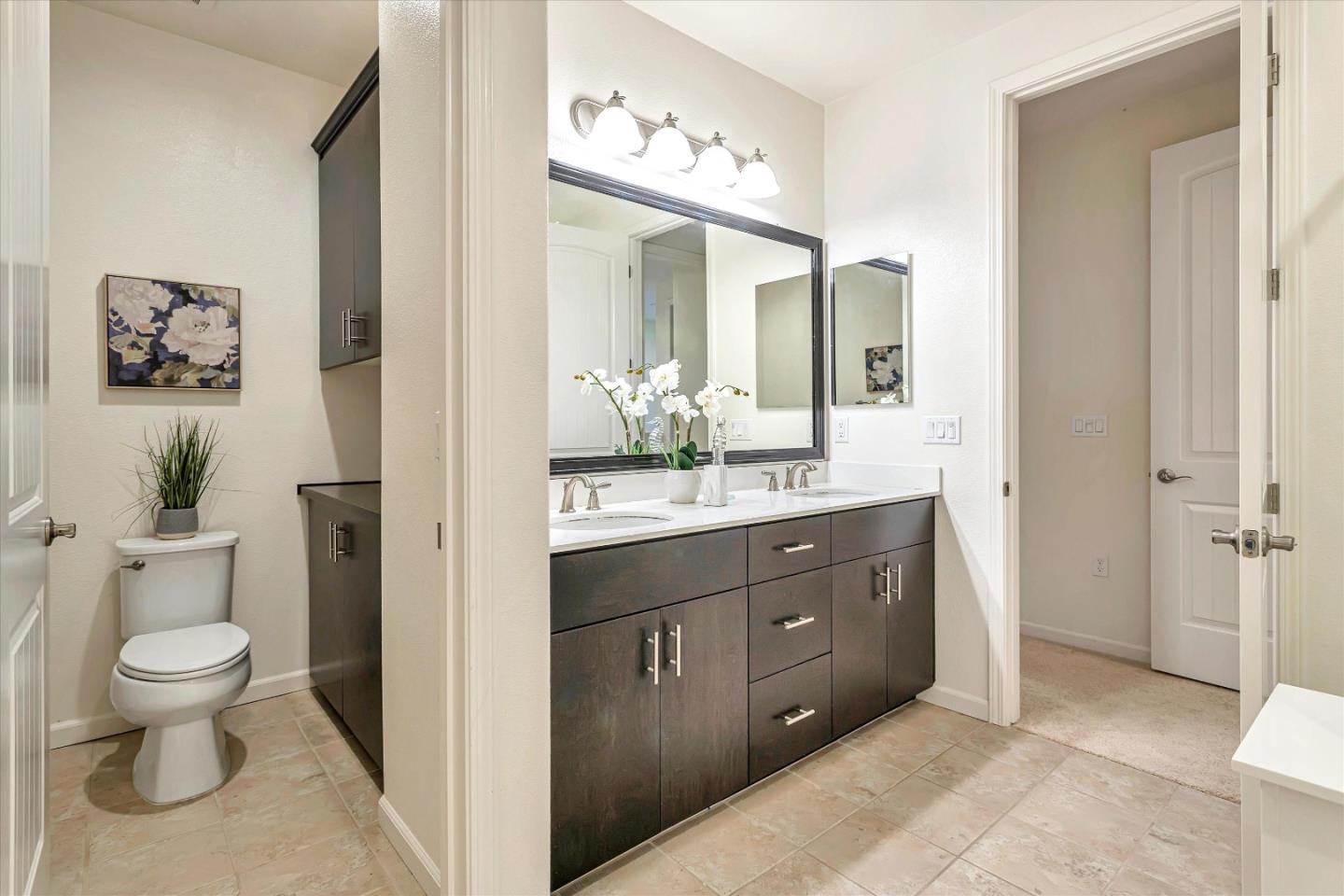 1886 Trento Loop Milpitas, CA 95035 - Photo 23 of 43 a bathroom with a toilet a sink and a large mirror