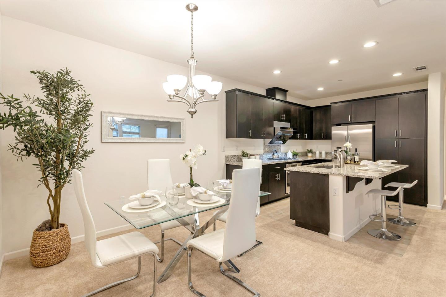 1886 Trento Loop Milpitas, CA 95035 - Photo 9 of 43 a kitchen with a sink a refrigerator and chairs