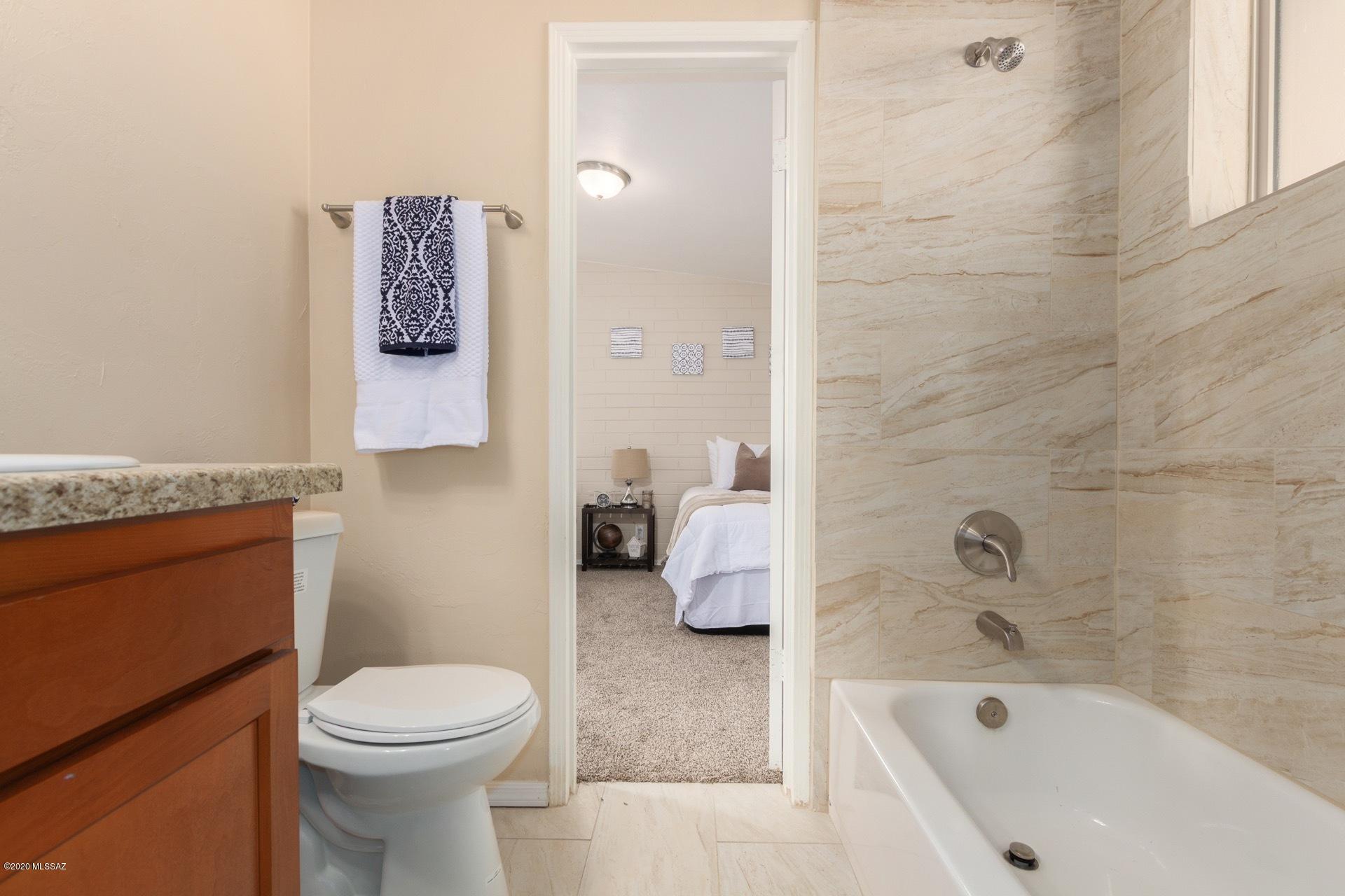 1043 East Navajo Road Tucson, AZ 85719 - Photo 18 of 25 a bathroom with a sink a toilet and shower
