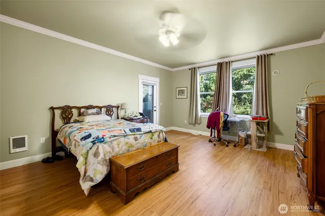 a bedroom with a bed and wooden floor