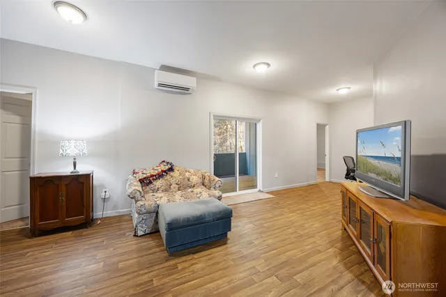 a bedroom with bed and wooden floor