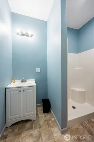 a kitchen with a refrigerator a stove top oven and a wooden floor
