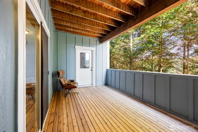 a view of a house with a yard and large trees