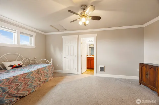 a bed room with a bed and a ceiling fan
