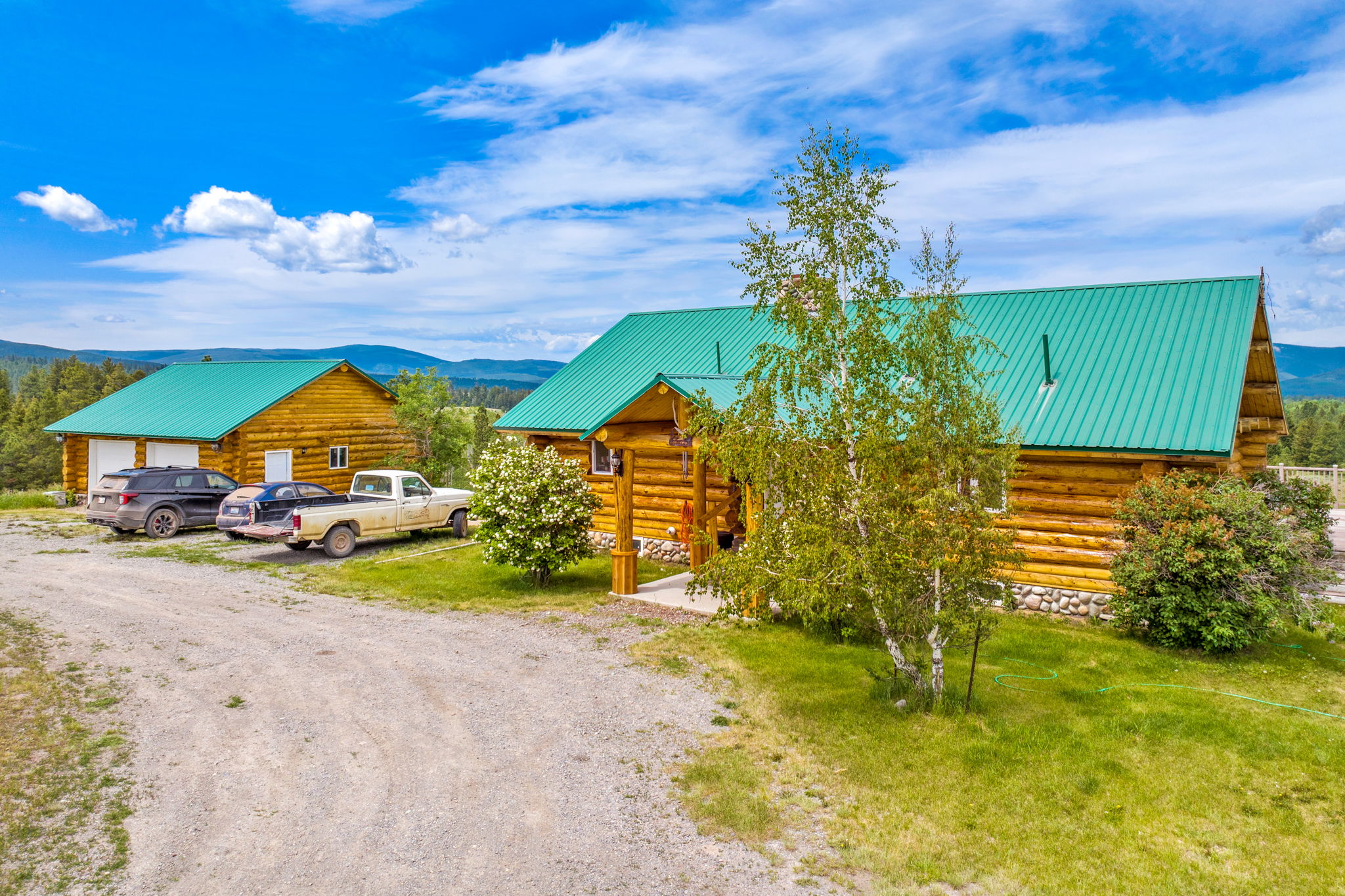 3358 Strandskov Road Lincoln, MT 59639 - Photo 62 of 80 Cabin featuring log siding, dirt driveway, and a metal roof