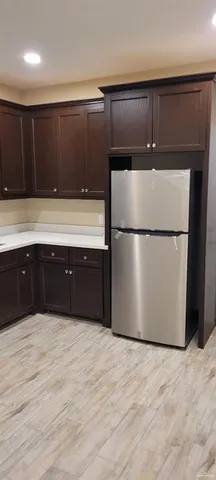 a kitchen with wooden cabinets