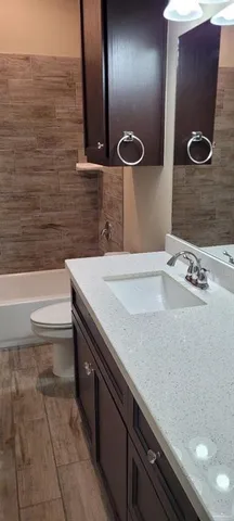 a bathroom with a sink a toilet and mirror